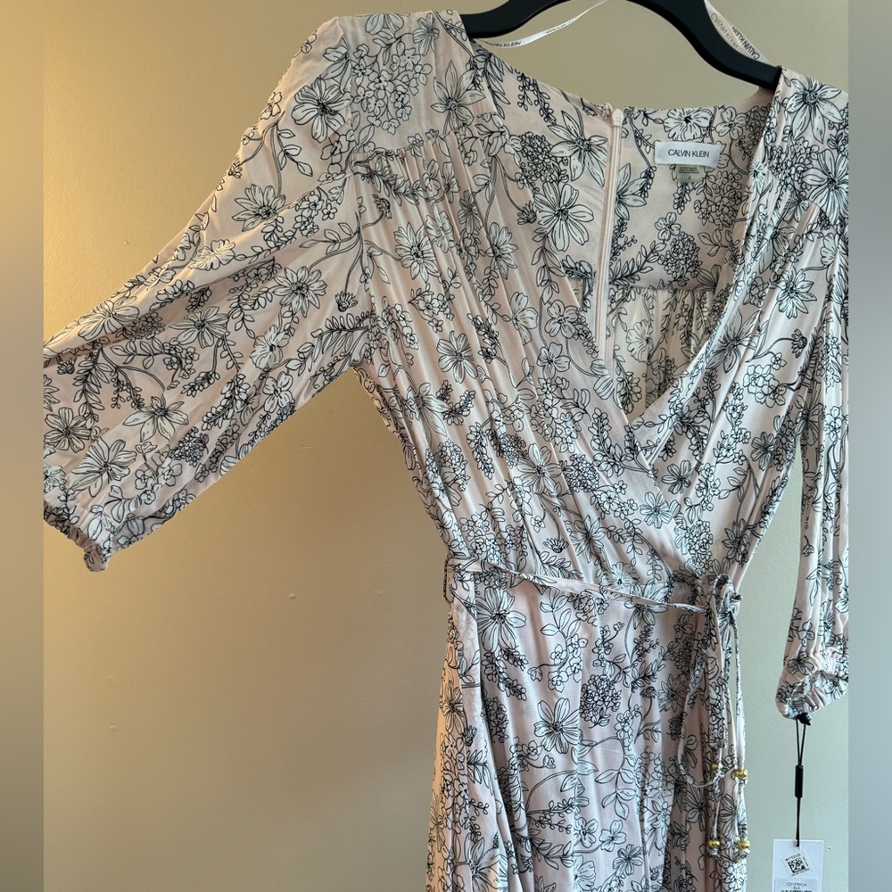 Never worn Calvin Klein size 6 light pink floral dress w/ sleeves. Knee length